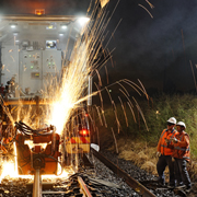 Industrial photography Auto welding on rail line at night